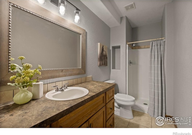 7717 Amour Hill Dr, Greeley, CO 80634 - bathroom with a shower stall, toilet, vanity, a textured wall, and tile patterned flooring