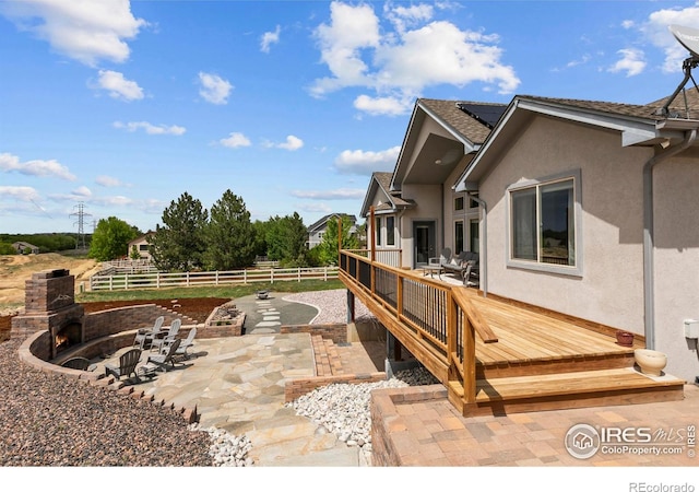 7717 Amour Hill Dr, Greeley, CO 80634 - deck with an outdoor fire pit, a patio area, and fence