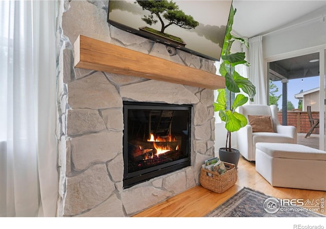 512 Prairie Clover Way, Severance, CO 80550 - detailed view of a stone fireplace and wood finished floors