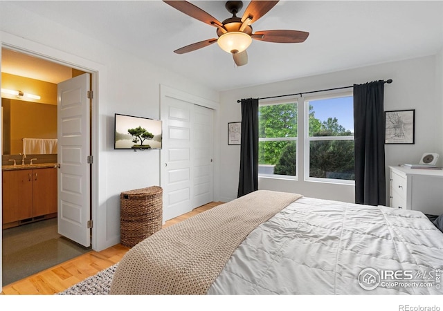 512 Prairie Clover Way, Severance, CO 80550 - bedroom with light wood-type flooring, a closet, a ceiling fan, and a sink