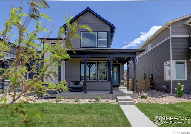 5282 Ribault St, Timnath, CO 80547 - view of front of property with a porch and a front lawn