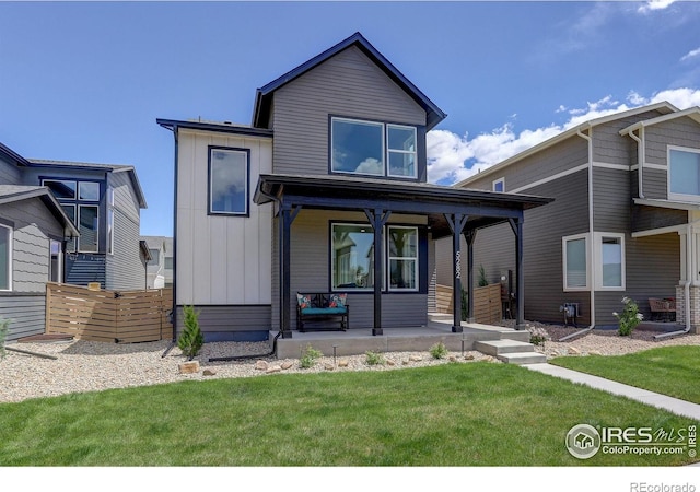 5282 Ribault St, Timnath, CO 80547 - modern home with covered porch, a front lawn, and board and batten siding