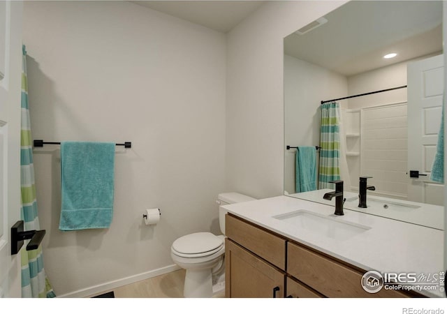 5282 Ribault St, Timnath, CO 80547 - bathroom with toilet, baseboards, wood finished floors, vanity, and a shower with shower curtain