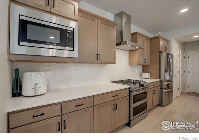 5282 Ribault St, Timnath, CO 80547 - kitchen with stainless steel appliances, wall chimney exhaust hood, light wood-style flooring, light countertops, and backsplash
