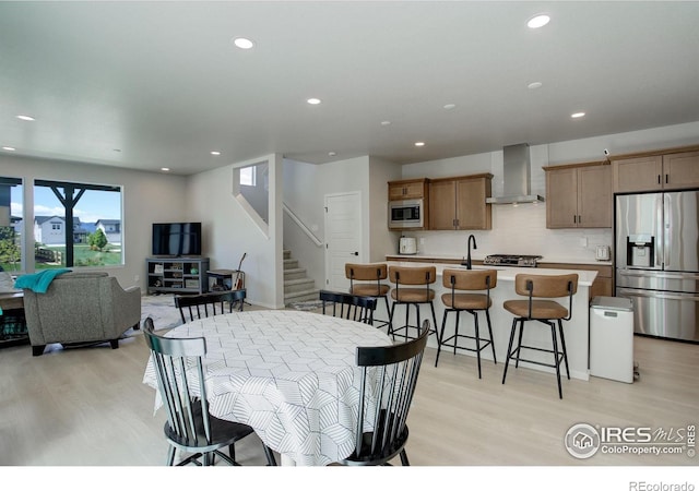 5282 Ribault St, Timnath, CO 80547 - dining area featuring light wood finished floors, recessed lighting, and stairway