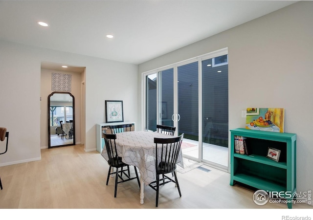 5282 Ribault St, Timnath, CO 80547 - dining space featuring light wood finished floors, recessed lighting, arched walkways, and baseboards