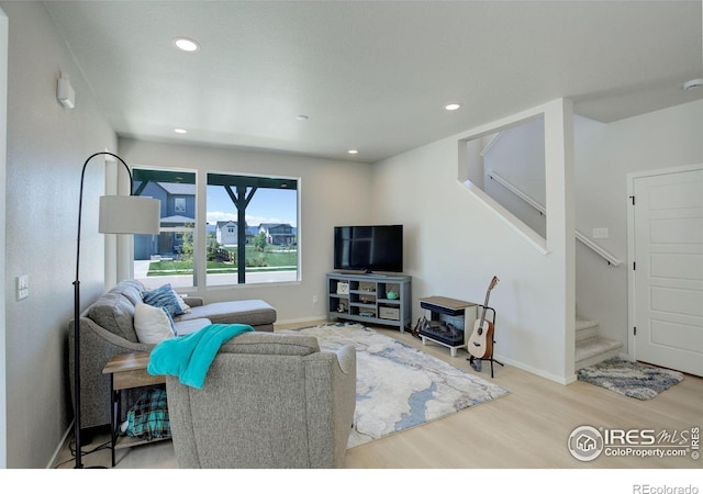 5282 Ribault St, Timnath, CO 80547 - living room featuring wood finished floors, stairway, recessed lighting, and baseboards