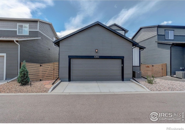 5282 Ribault St, Timnath, CO 80547 - view of front of house with central air condition unit, fence, concrete driveway, and an attached garage