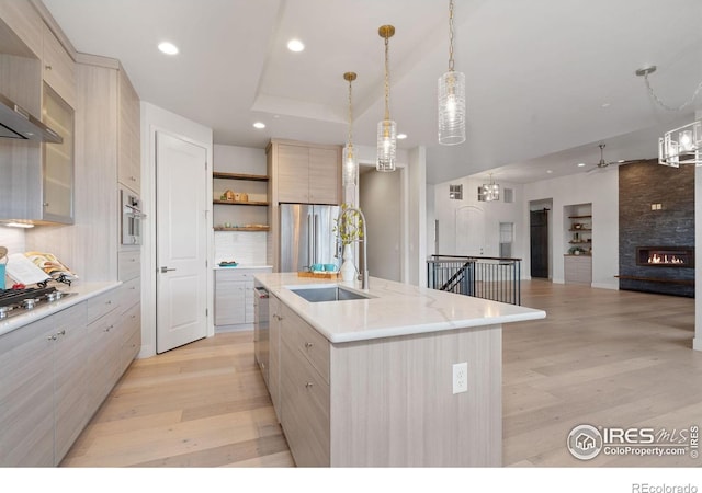 4014 Rock Creek Dr, Fort Collins, CO 80528 - kitchen featuring open shelves, light wood-style floors, modern cabinets, a center island with sink, and recessed lighting
