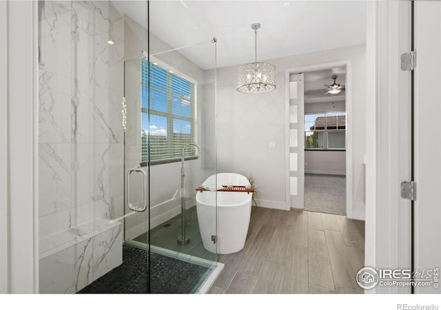 4014 Rock Creek Dr, Fort Collins, CO 80528 - bathroom with a freestanding bath, healthy amount of natural light, wood finish floors, and baseboards