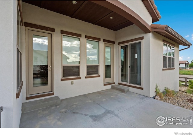 4014 Rock Creek Dr, Fort Collins, CO 80528 - property entrance with stucco siding and a patio area