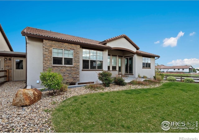 4014 Rock Creek Dr, Fort Collins, CO 80528 - rear view of property with stucco siding, a yard, stone siding, and a tiled roof