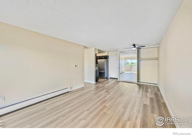 4110 Hale Pkwy # 5F, Denver, CO 80220 - unfurnished living room with a baseboard radiator, light wood-type flooring, a textured ceiling, ceiling fan, and baseboards