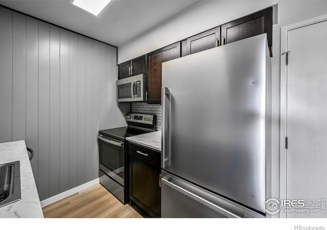 4110 Hale Pkwy # 5F, Denver, CO 80220 - kitchen with appliances with stainless steel finishes, light wood-style flooring, a sink, dark brown cabinets, and backsplash