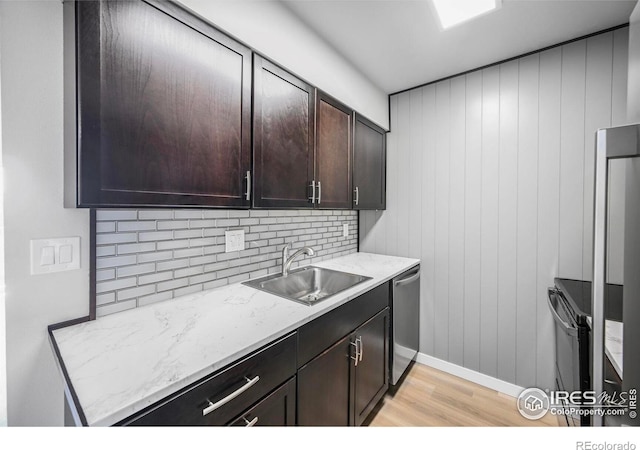 4110 Hale Pkwy # 5F, Denver, CO 80220 - kitchen featuring a sink, stainless steel dishwasher, light wood-style floors, dark brown cabinets, and tasteful backsplash
