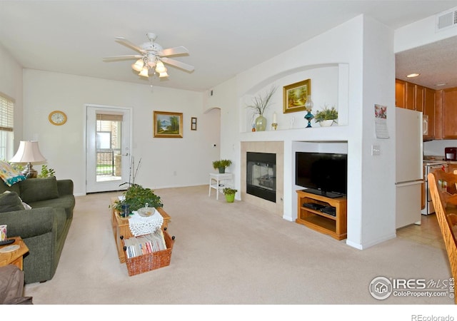 5014 Northern Lights Dr, Fort Collins, CO 80528 - living room with a tiled fireplace, light colored carpet, ceiling fan, and baseboards