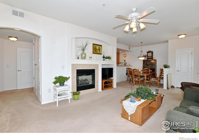 5014 Northern Lights Dr, Fort Collins, CO 80528 - living area featuring carpet, ceiling fan, arched walkways, a fireplace, and baseboards