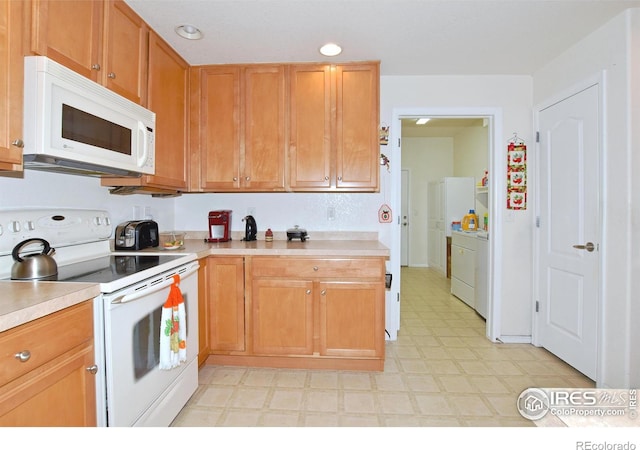 5014 Northern Lights Dr, Fort Collins, CO 80528 - kitchen with white appliances, light flooring, light countertops, washer / clothes dryer, and recessed lighting