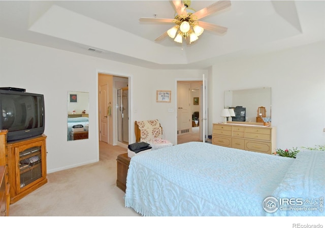5014 Northern Lights Dr, Fort Collins, CO 80528 - bedroom featuring a tray ceiling, light carpet, and a ceiling fan