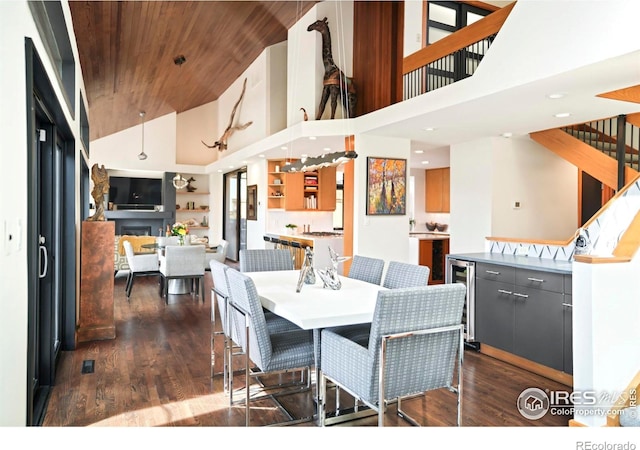 3746 Wonderland Hill Ave, Boulder, CO 80304 - dining area with wine cooler, wood ceiling, dark wood-style floors, high vaulted ceiling, and a fireplace