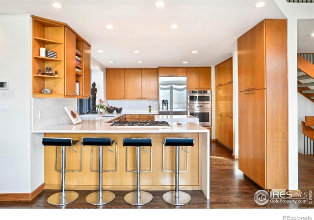 3746 Wonderland Hill Ave, Boulder, CO 80304 - kitchen featuring appliances with stainless steel finishes, a peninsula, dark wood finished floors, light countertops, and open shelves