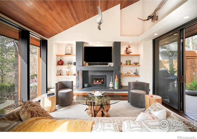 3746 Wonderland Hill Ave, Boulder, CO 80304 - living room featuring built in shelves, vaulted ceiling, wood ceiling, a warm lit fireplace, and recessed lighting