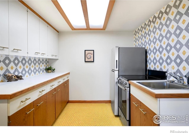3746 Wonderland Hill Ave, Boulder, CO 80304 - kitchen with a sink, light floors, stainless steel electric range, backsplash, and white cabinetry