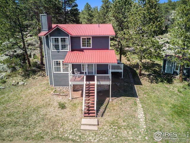 60 Horn Peak Dr, Livermore, CO 80536 - view of front of property featuring a chimney, metal roof, a front lawn, and stairs