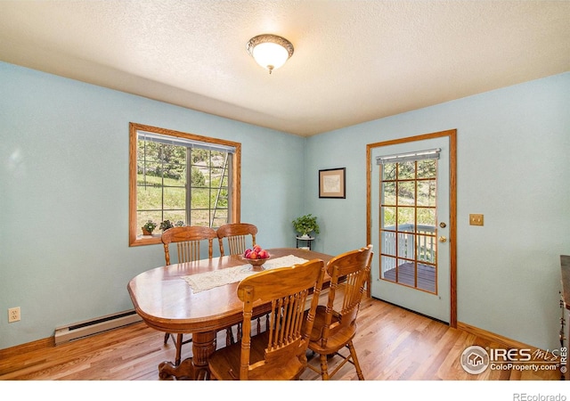 60 Horn Peak Dr, Livermore, CO 80536 - dining area with a baseboard radiator, light wood finished floors, plenty of natural light, and a textured ceiling