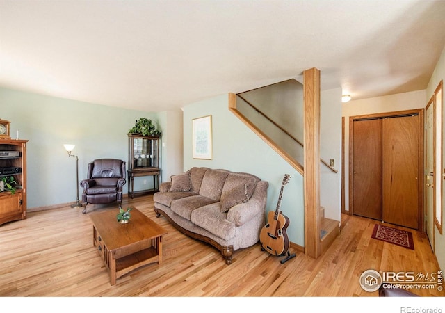 60 Horn Peak Dr, Livermore, CO 80536 - living room featuring stairway, light wood-type flooring, and baseboards