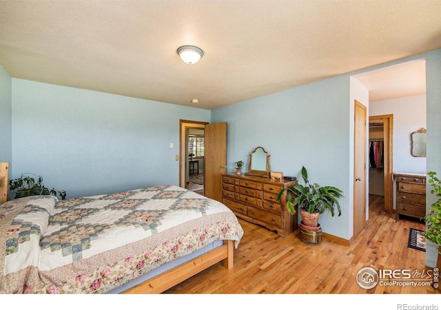 60 Horn Peak Dr, Livermore, CO 80536 - bedroom featuring wood finished floors, baseboards, and a spacious closet