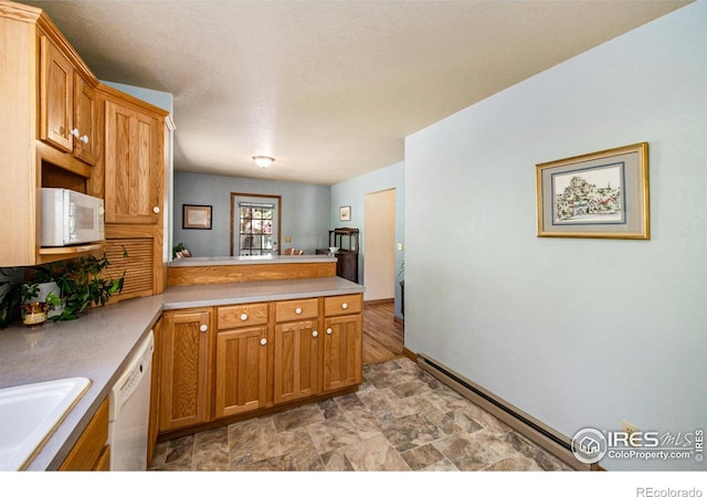 60 Horn Peak Dr, Livermore, CO 80536 - kitchen featuring white appliances, a peninsula, stone finish floors, light countertops, and a sink
