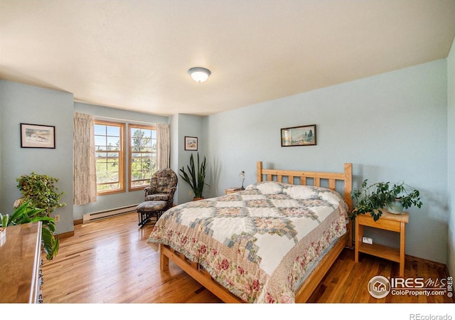 60 Horn Peak Dr, Livermore, CO 80536 - bedroom featuring baseboard heating, wood finished floors, and baseboards