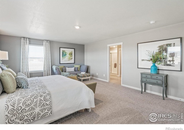 bedroom with baseboards, carpet, and connected bathroom