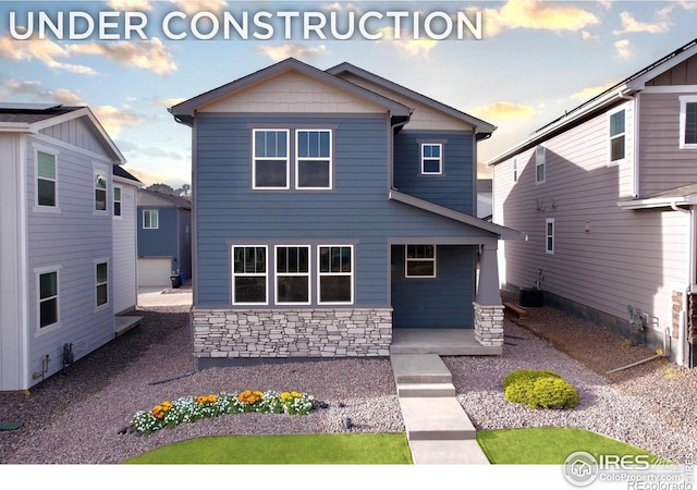 6032 Windy Willow Dr, Fort Collins, CO 80528 - craftsman-style home featuring stone siding and cooling unit