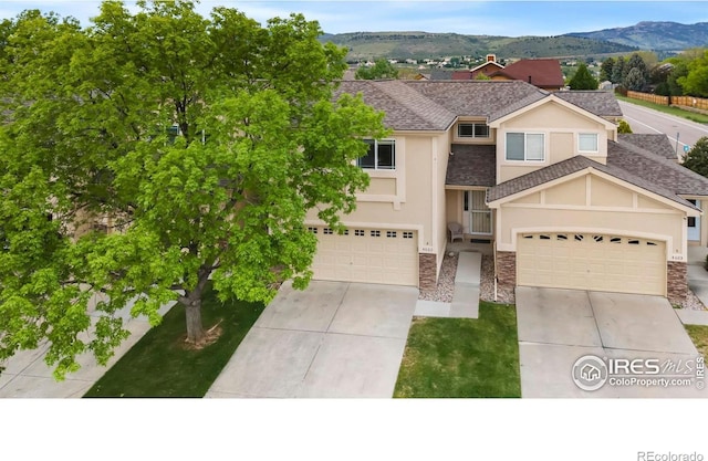 4603 Dusty Sage Ct Unit 4, Fort Collins, CO 80526 - view of front of property featuring concrete driveway, stone siding, stucco siding, and a shingled roof