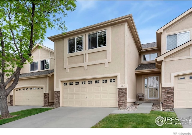 4603 Dusty Sage Ct Unit 4, Fort Collins, CO 80526 - view of front of home with stone siding, stucco siding, a garage, and driveway
