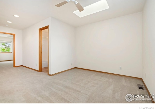 4603 Dusty Sage Ct Unit 4, Fort Collins, CO 80526 - spare room with a skylight, light colored carpet, ceiling fan, baseboards, and recessed lighting