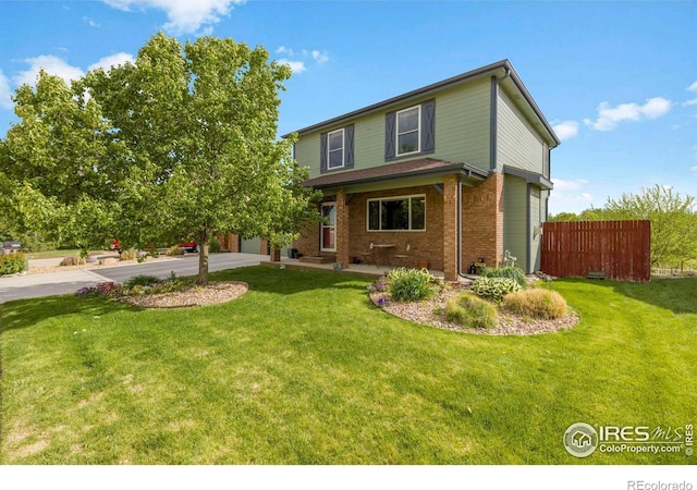 5196 32nd St, Greeley, CO 80634 - traditional home with driveway, brick siding, and a garage
