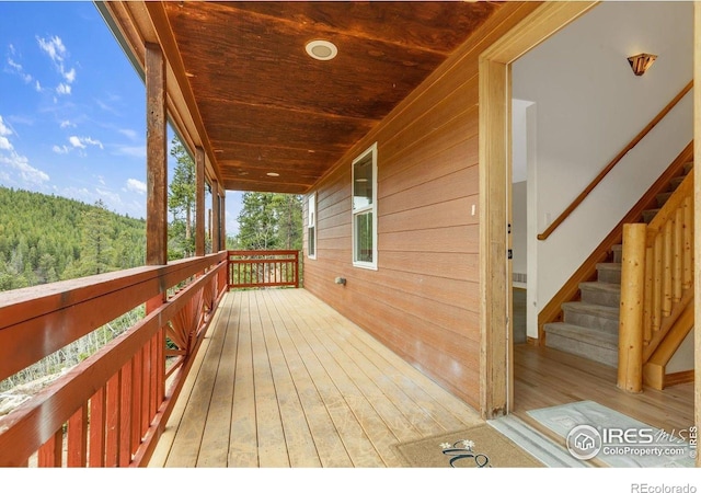 65 La Chula Rd, Black Hawk, CO 80422 - wooden deck with a wooded view and covered porch