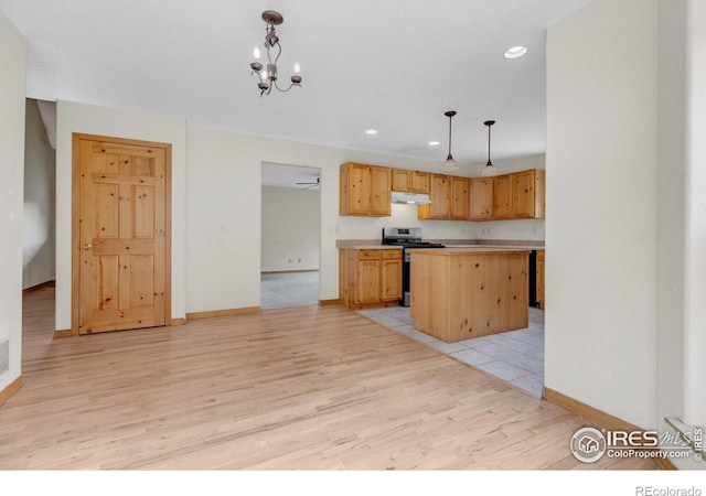 65 La Chula Rd, Black Hawk, CO 80422 - kitchen featuring stainless steel gas stove, under cabinet range hood, light wood-type flooring, light countertops, and baseboards