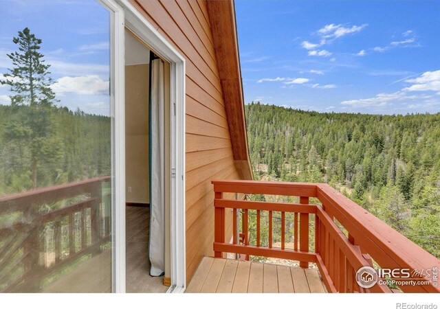 65 La Chula Rd, Black Hawk, CO 80422 - wooden deck featuring a wooded view