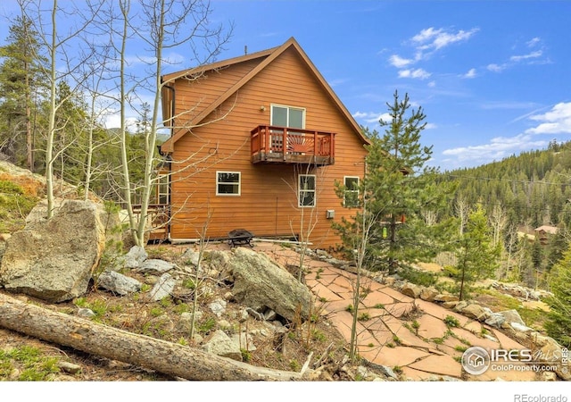 65 La Chula Rd, Black Hawk, CO 80422 - view of property exterior featuring a balcony and a wooded view