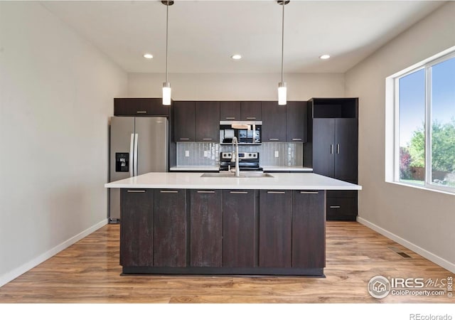 10069 Richfield St, Commerce City, CO 80022 - kitchen with stainless steel appliances, a sink, light countertops, light wood-style floors, and recessed lighting