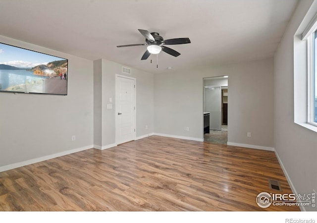 10069 Richfield St, Commerce City, CO 80022 - unfurnished room featuring wood finished floors, ceiling fan, plenty of natural light, and baseboards