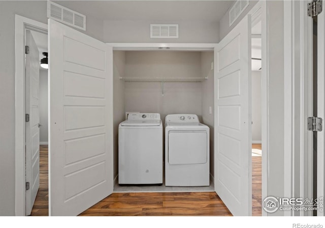 10069 Richfield St, Commerce City, CO 80022 - clothes washing area with separate washer and dryer and wood finished floors