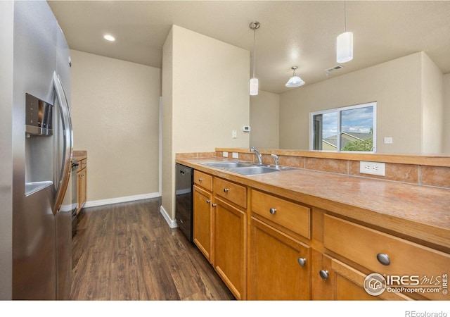 kitchen featuring stainless steel refrigerator with ice dispenser, a sink, black dishwasher, brown cabinets, and dark wood-style floors