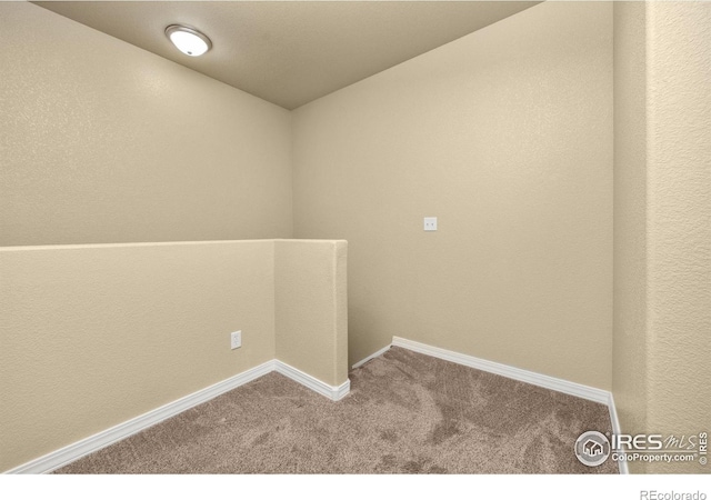 empty room with carpet and baseboards