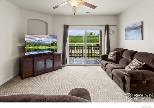 living area with carpet floors and a ceiling fan