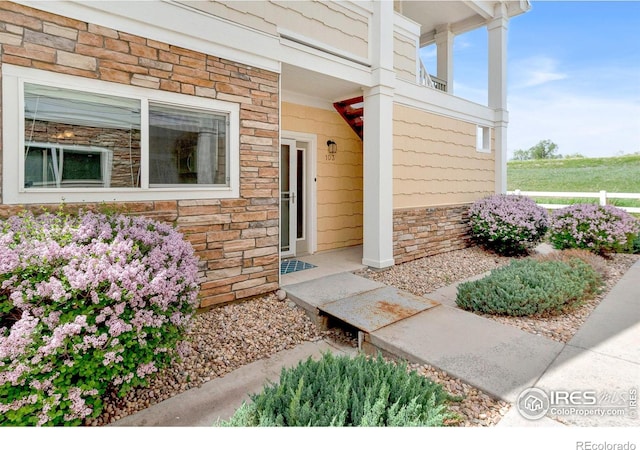 entrance to property with stone siding